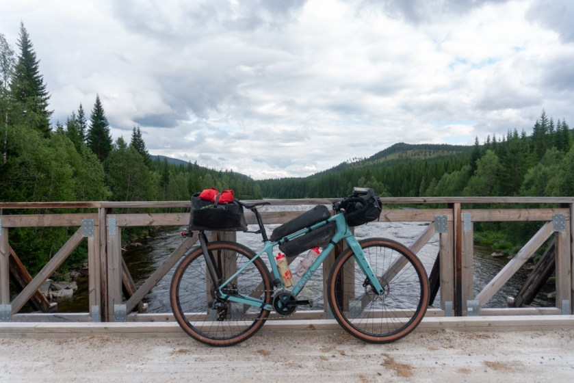 Kona Ouroboros against a river crossing