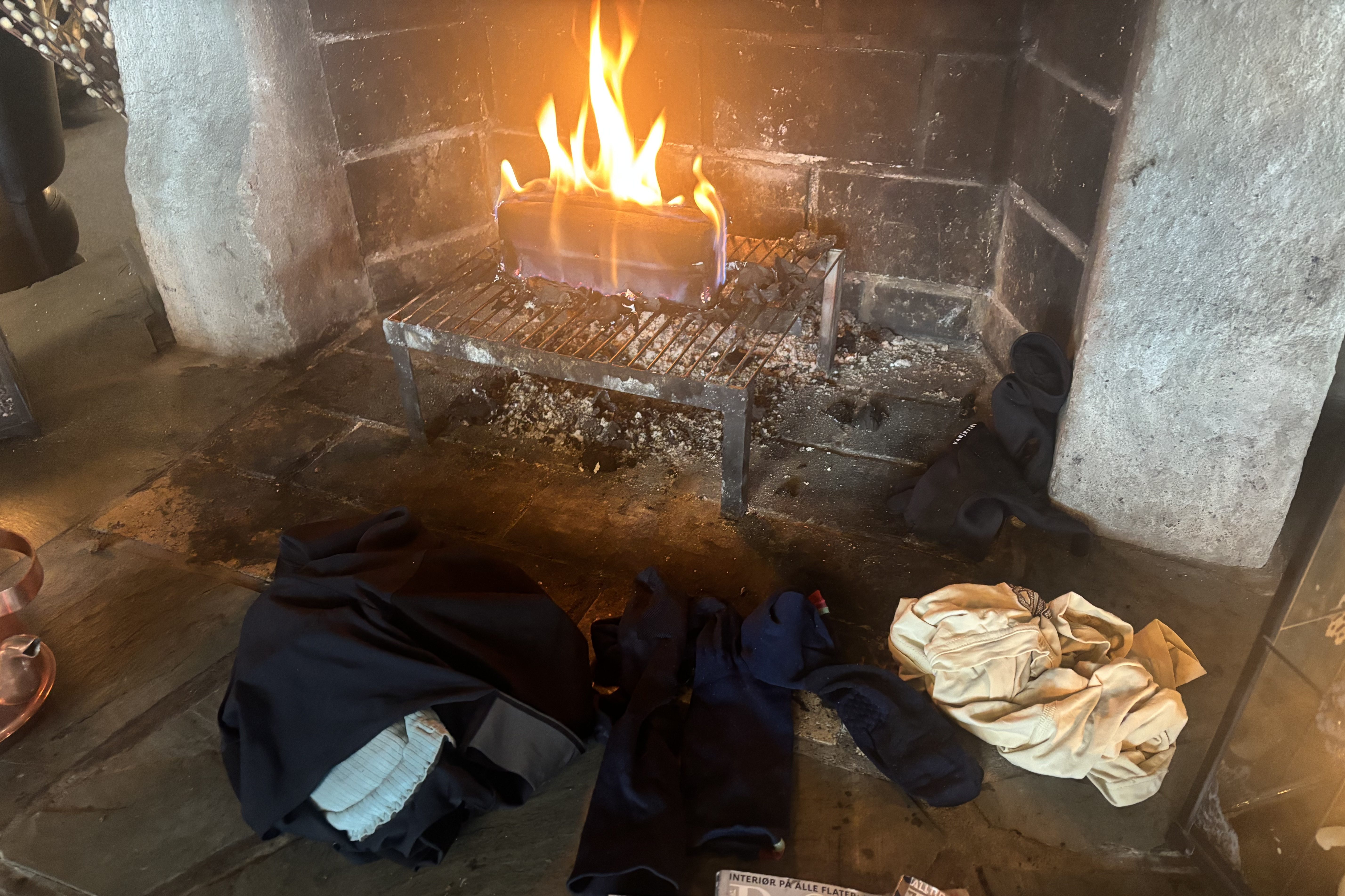 Clothes drying by a fire